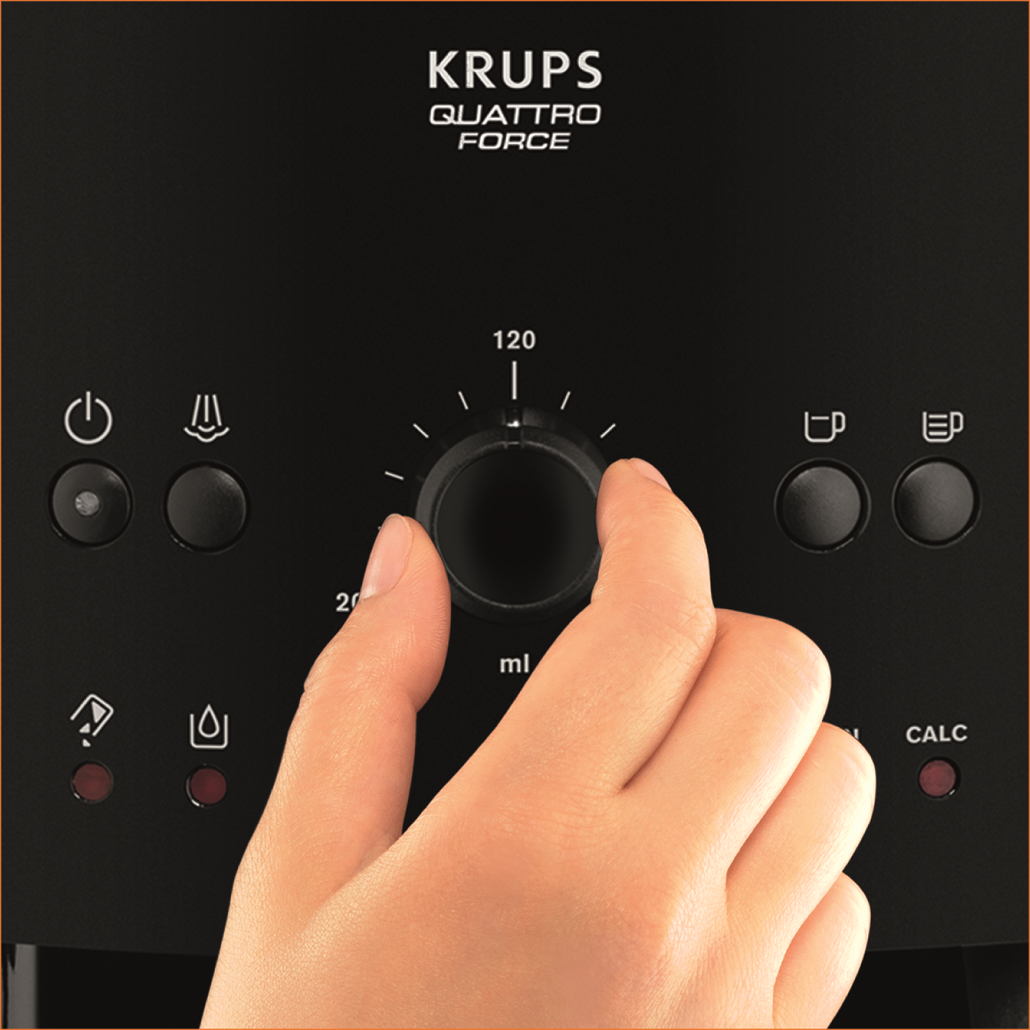 Una mano gira un dial en una cafetera Krups negra.