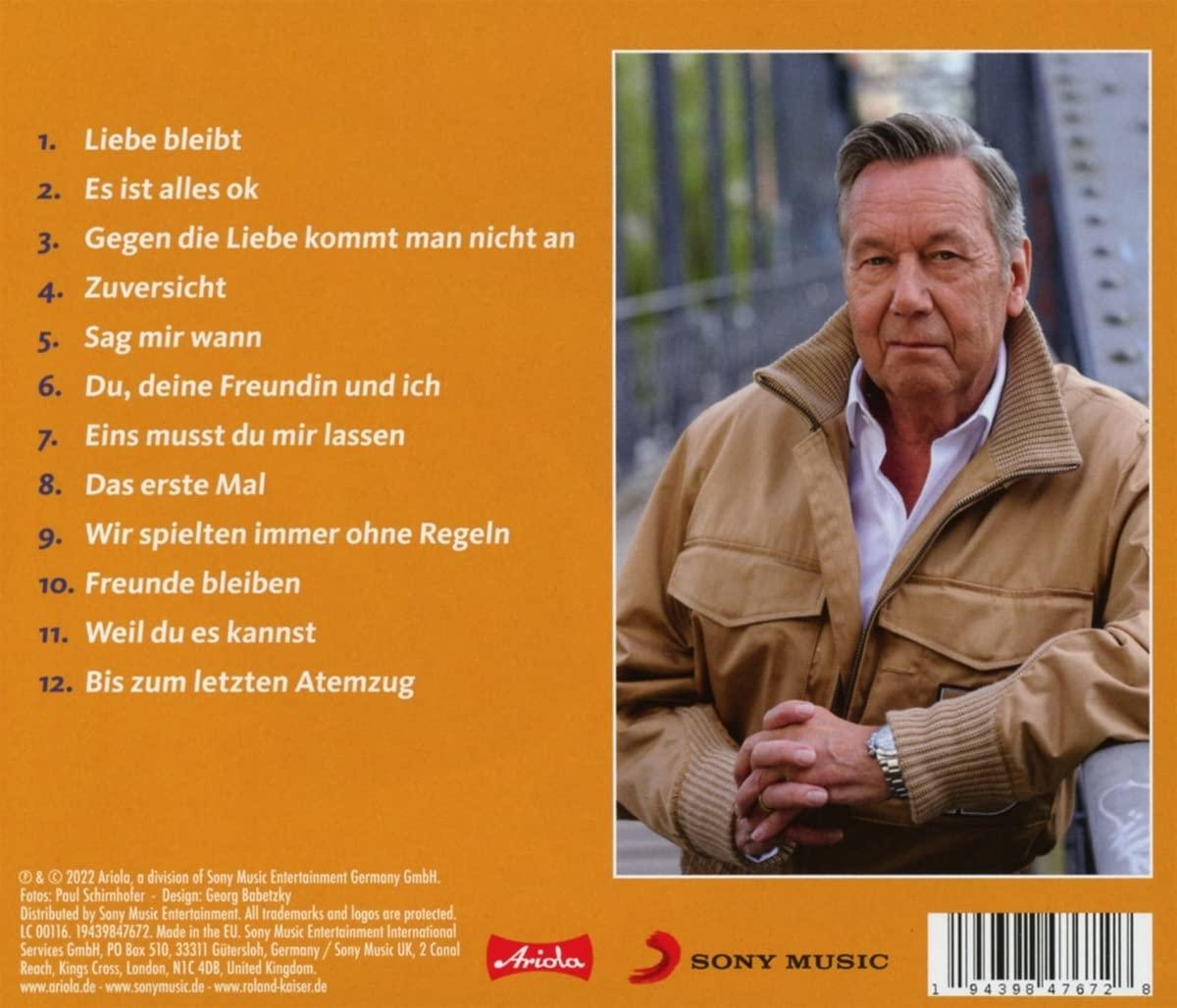 CD-Cover mit einem Mann, der sein Kinn hält, und Text darüber.