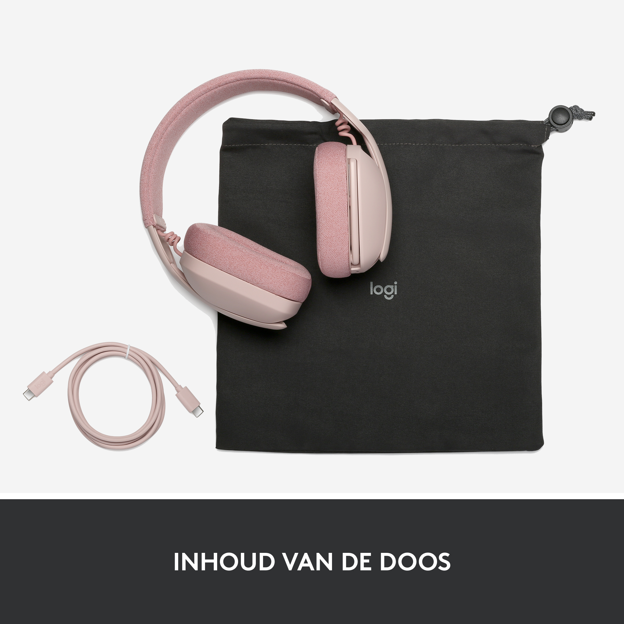 Roze koptelefoon met een zwarte hoes en een roze oplaadkabel, op een wit oppervlak.