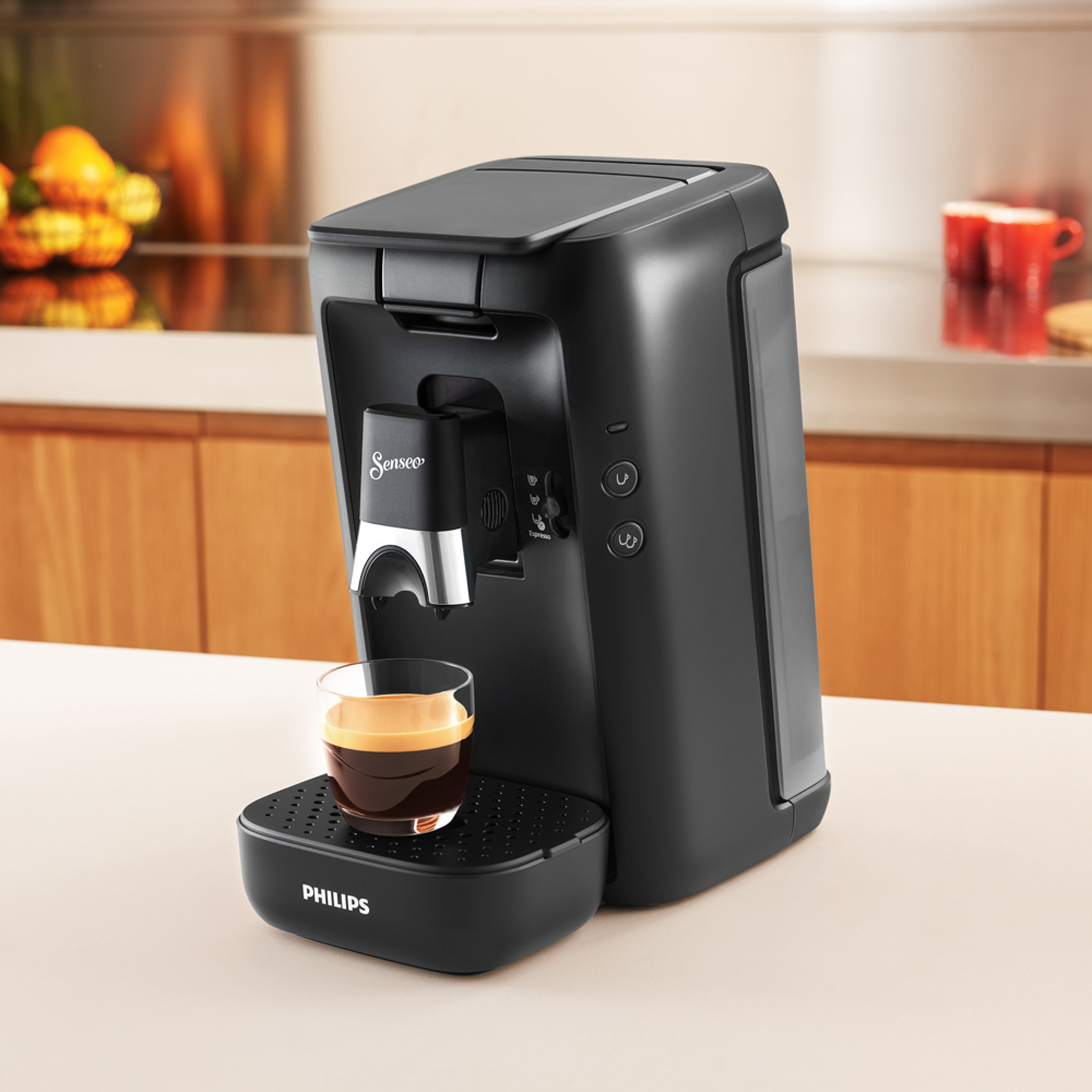 Black Senseo coffee machine with a cup of coffee on a counter.