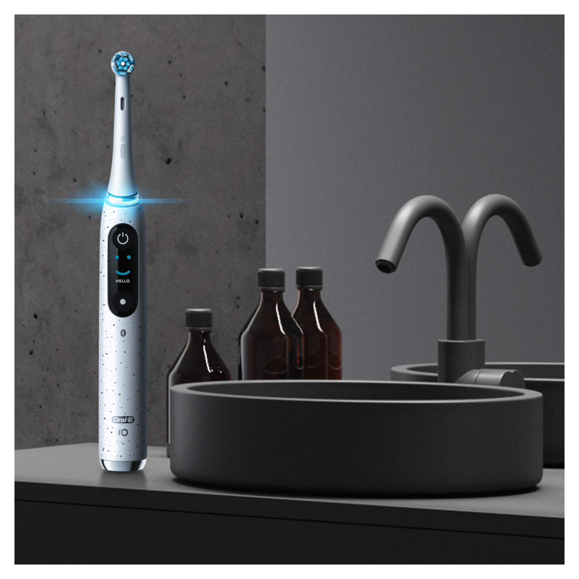 Electric toothbrush on a counter with other accessories.