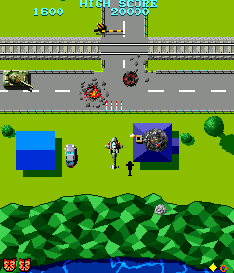 Eine Retro-Videospielszene. Ein Panzer, ein Auto, ein Hubschrauber und Explosionen sind auf Straßen und einer grünen Landschaft mit blauem Wasser zu sehen.