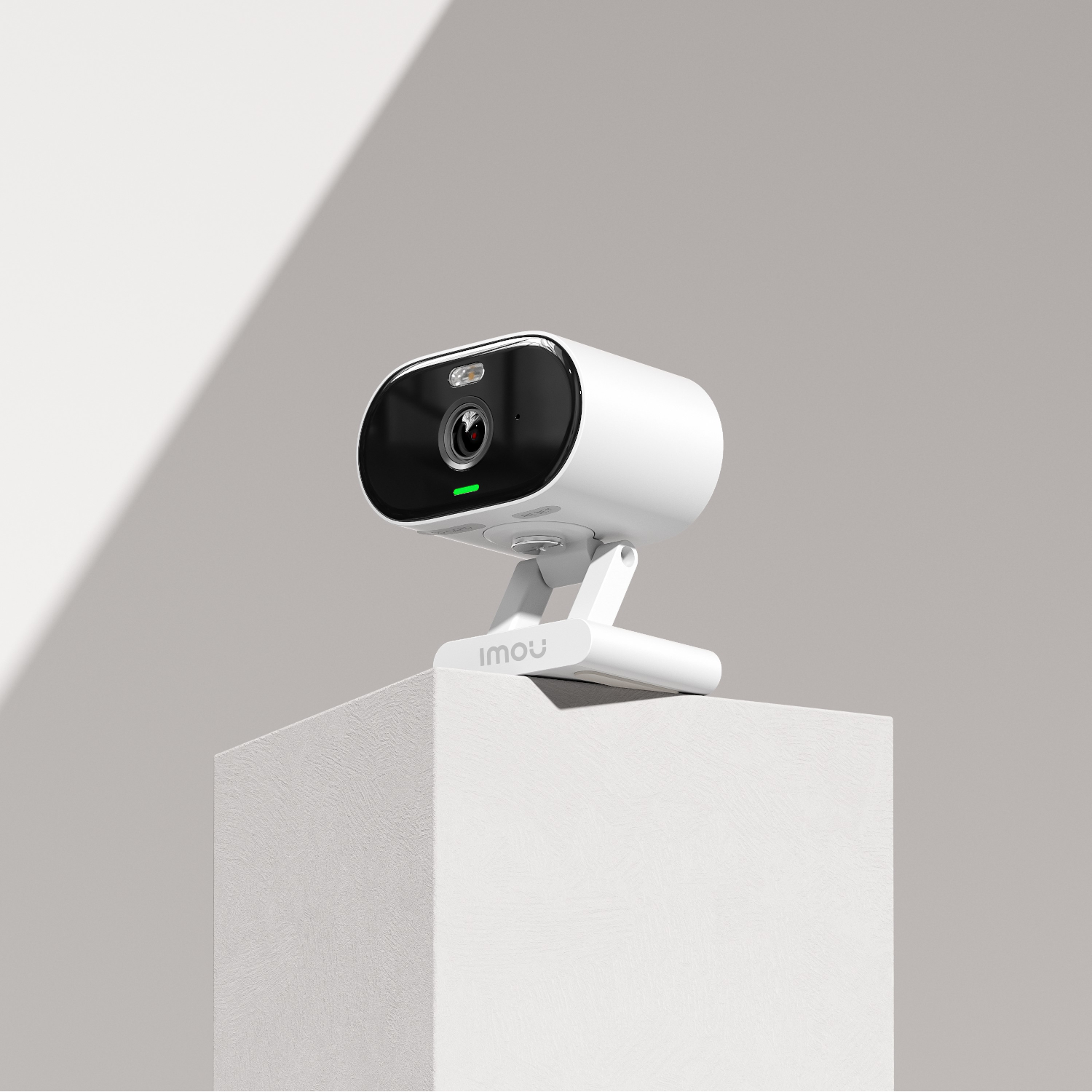 White security camera on a white block, with the brand name Imou.
