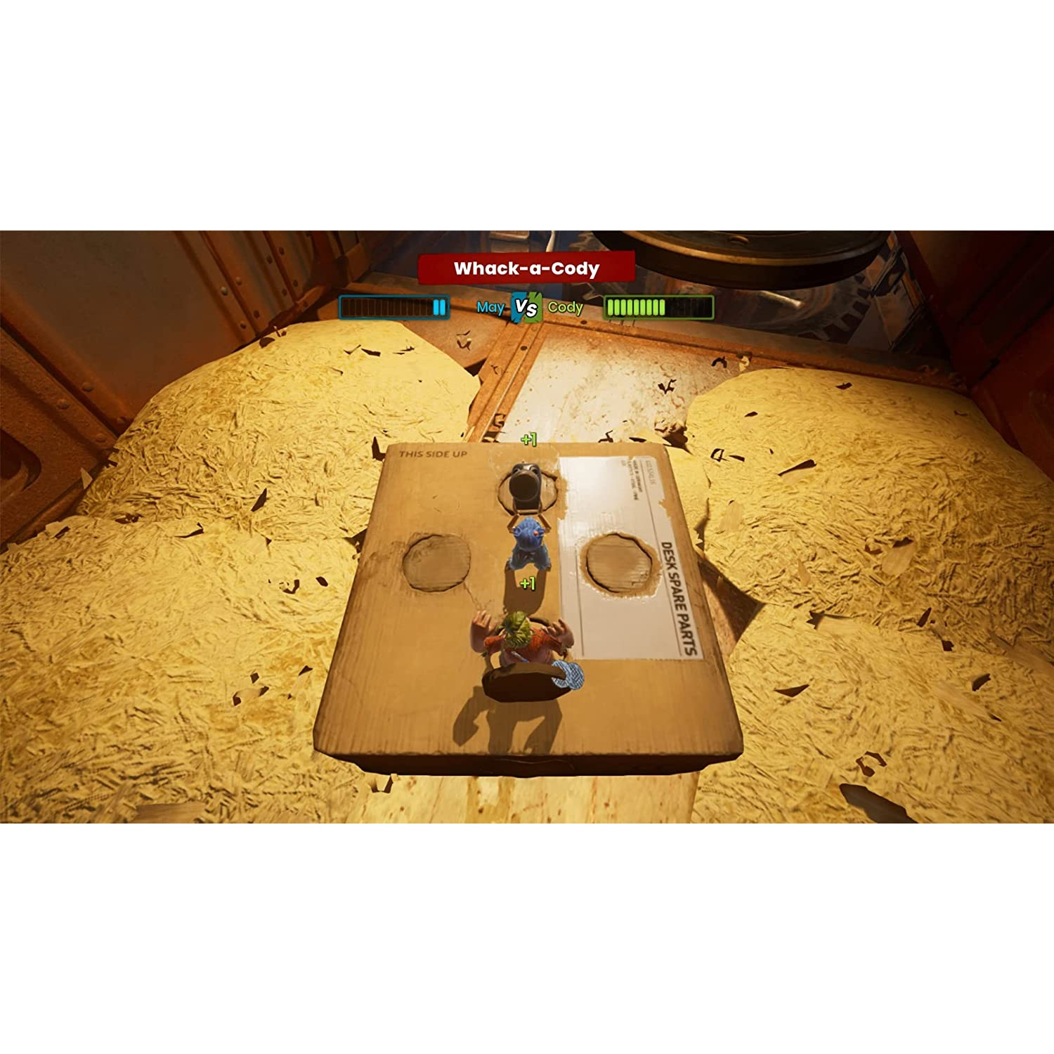 Una pantalla de videojuego. Dos personajes en una caja de cartón luchando. Paja amarilla los rodea.