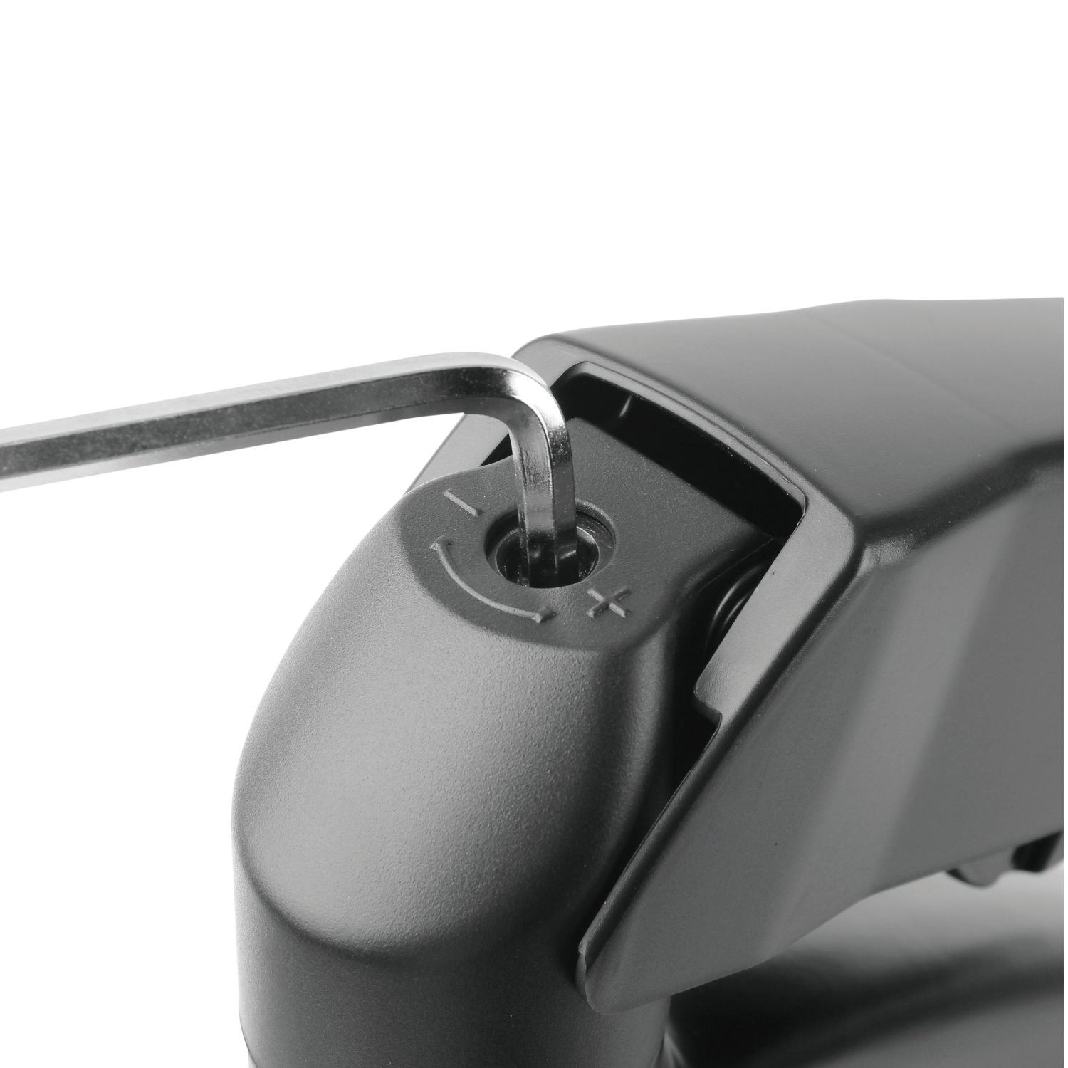 A silver hex key is inserted into a black component's screw.