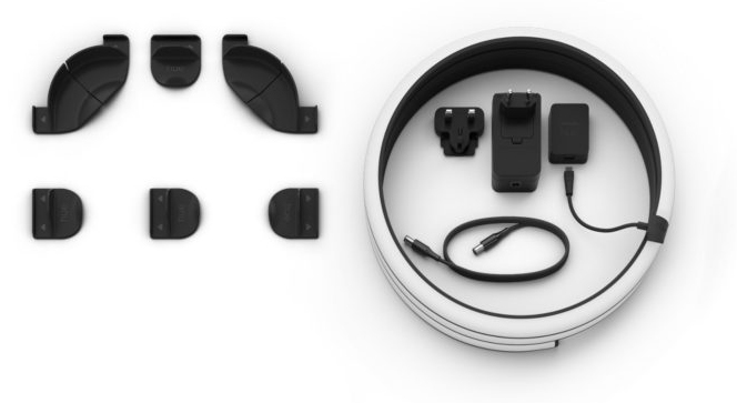 Assorted smart home devices are arranged on a white surface.