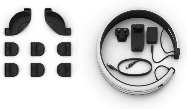 An arrangement of black items. Two sets of three items and a circular object with various components.