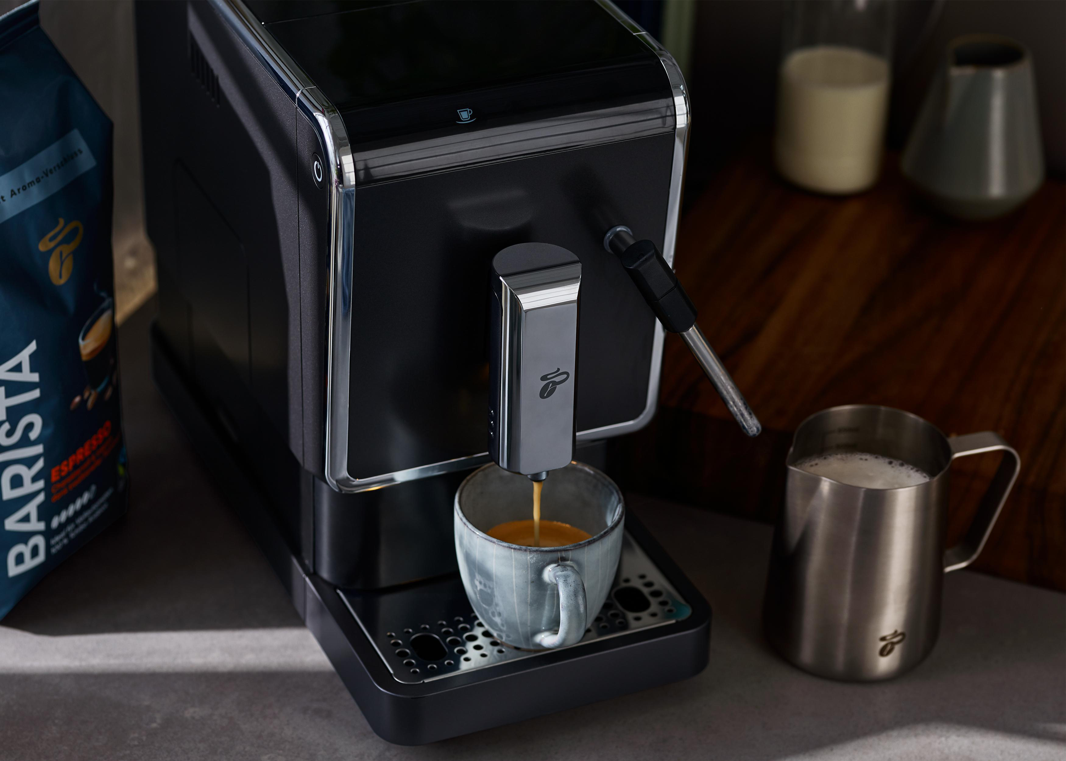 Eine Kaffeemaschine brüht Kaffee in eine Tasse.
