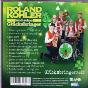 CD-Cover mit einer Musikergruppe mit Instrumenten auf grünem Hintergrund mit Kleeblättern und Text.
