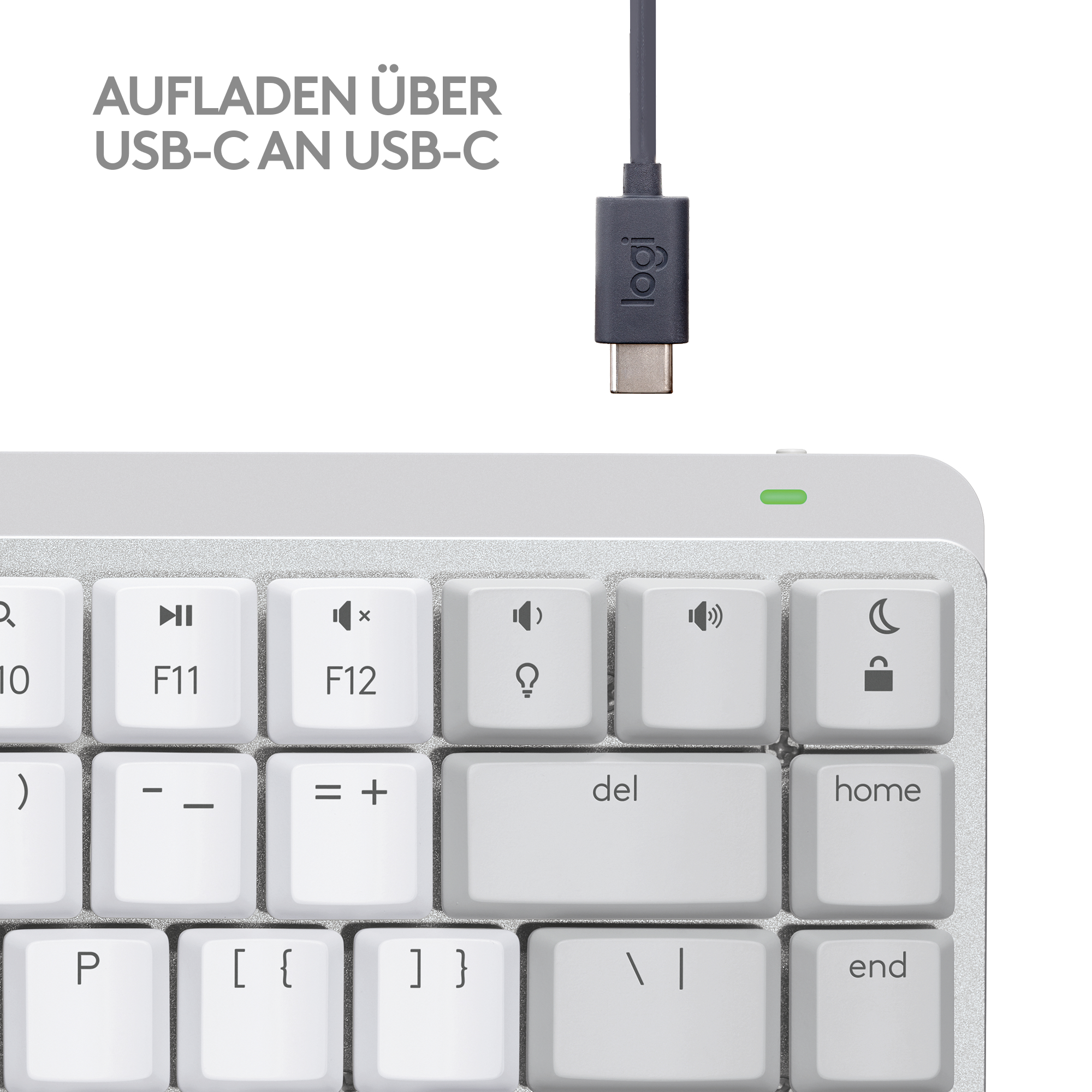 Eine weiße Tastatur mit Tasten, einem USB-C-Kabel und einem grünen Licht.