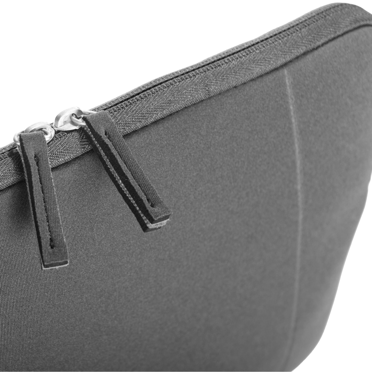 Close-up of a gray laptop sleeve with a zipper and two pull tabs.