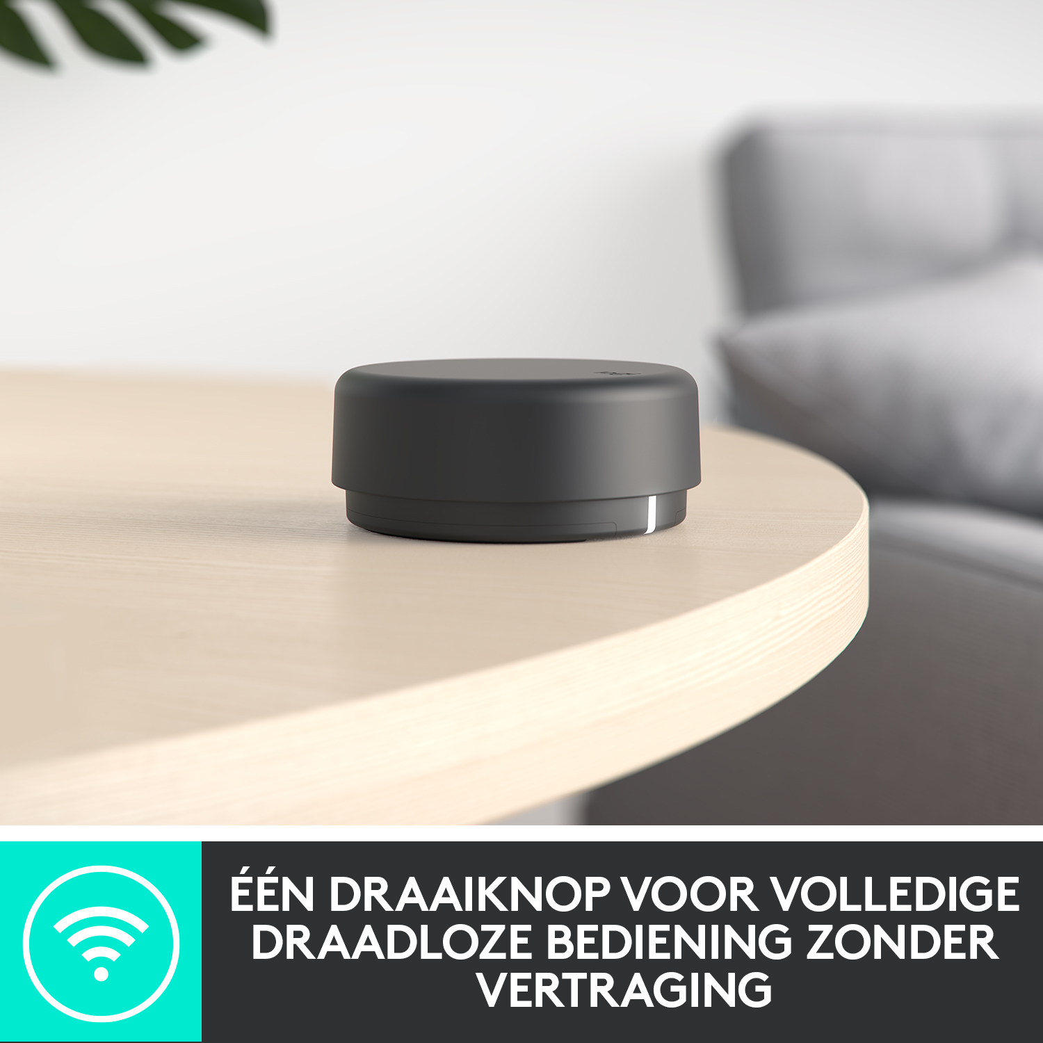 Black device on a wooden table. White text at the bottom.