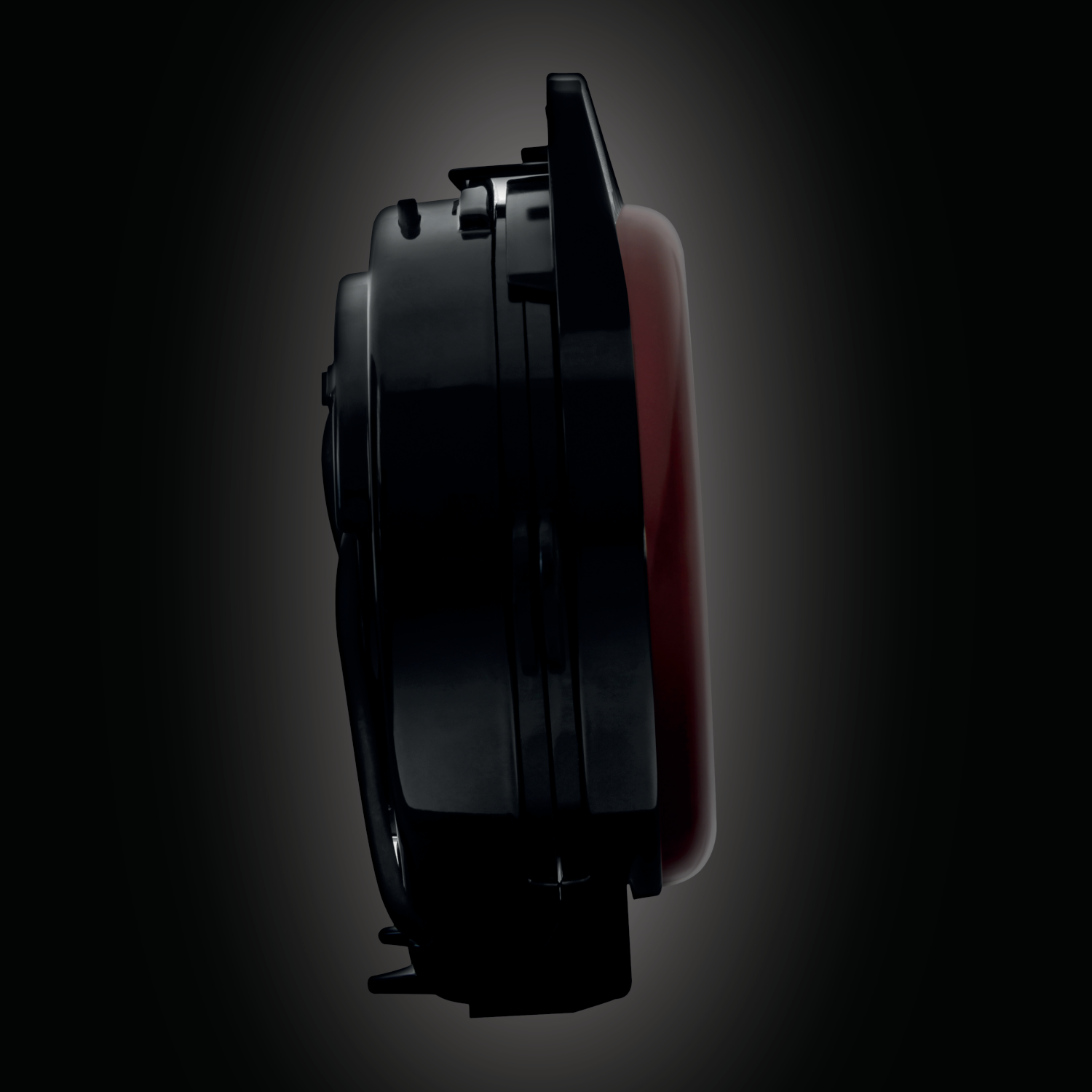 Black device with a red screen, showing its side profile.