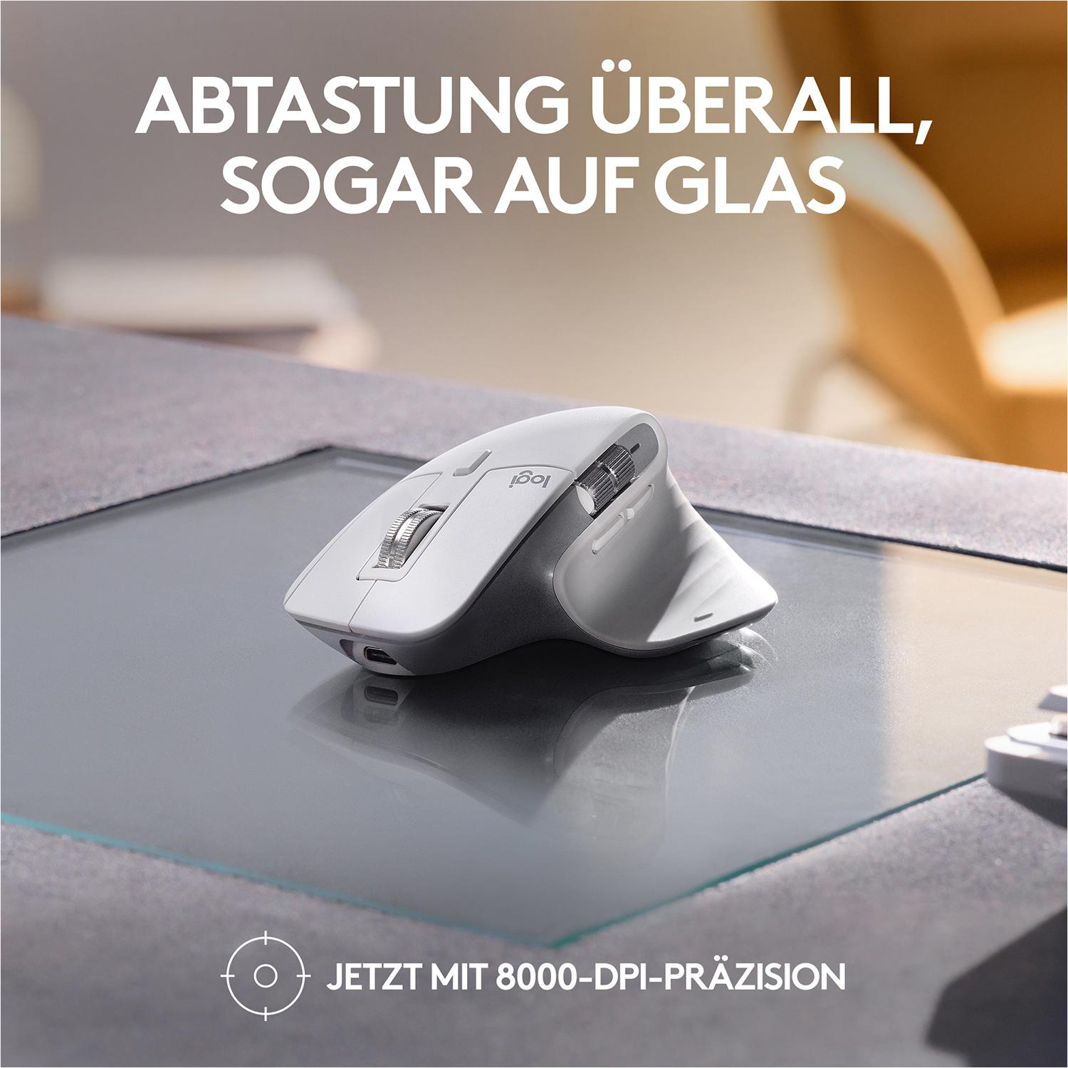 Eine weiße Computermaus auf einer Glasoberfläche. Text: Abtastung überall, auch auf Glas.