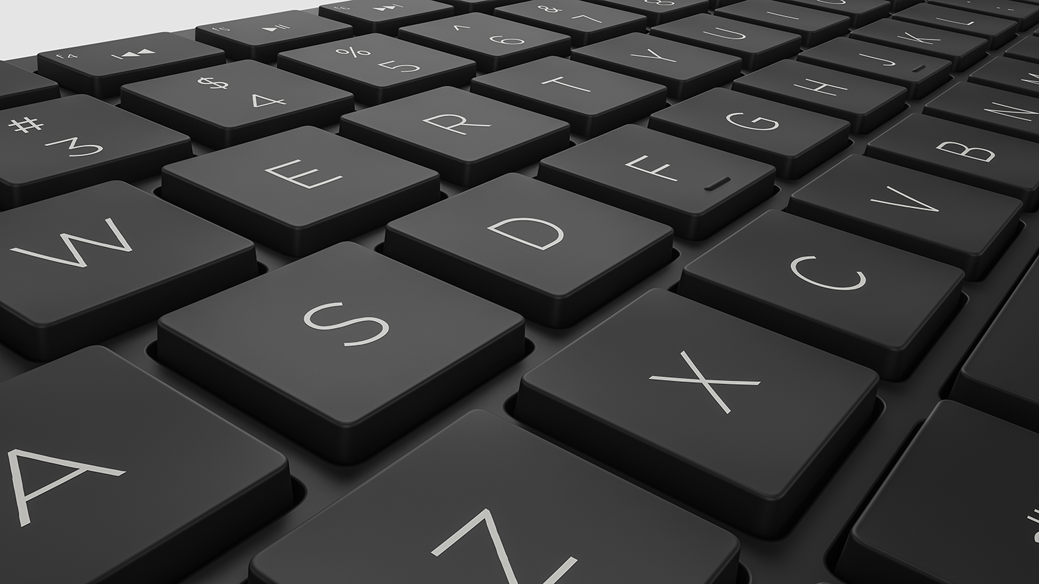 Close-up of a black keyboard with white letters.