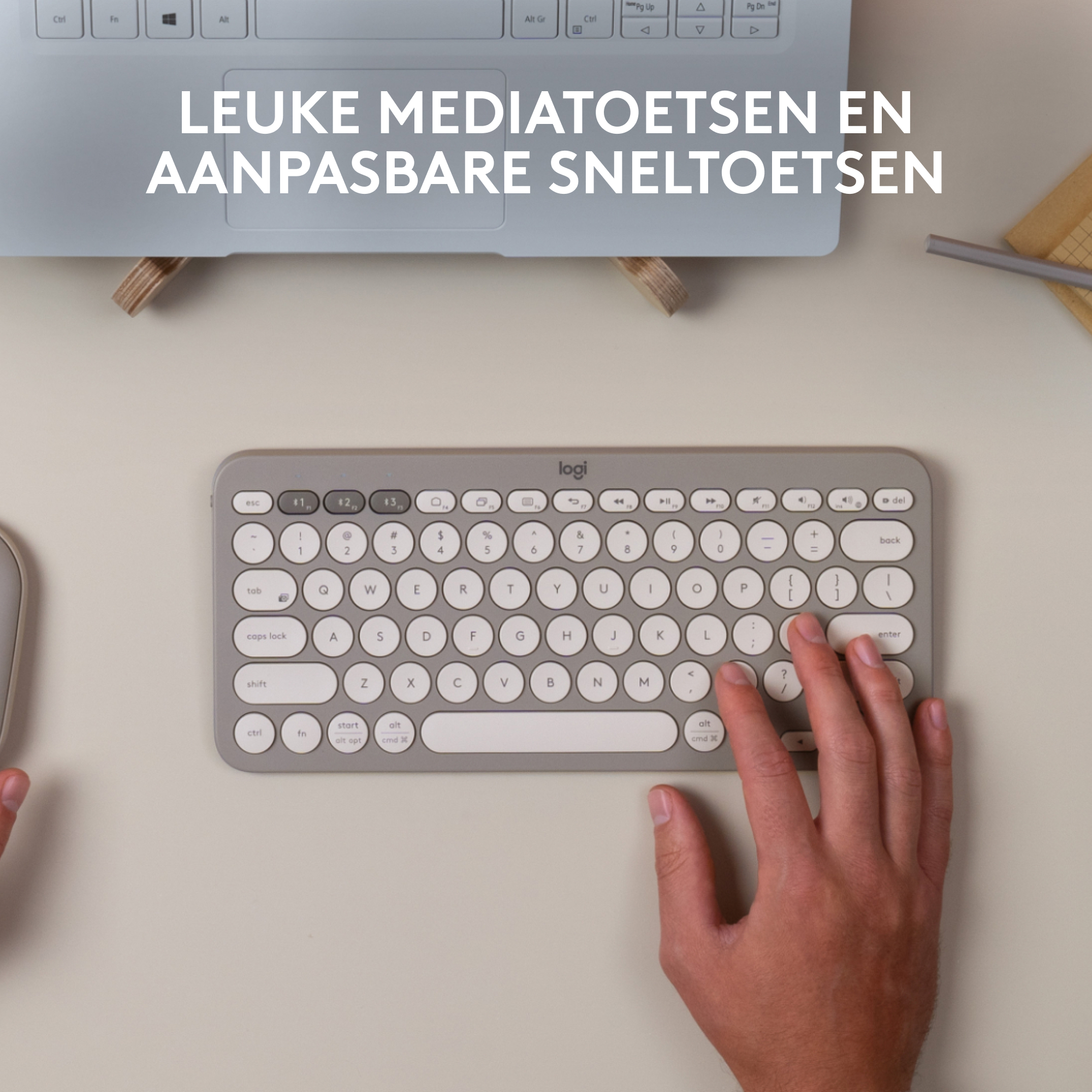 Een toetsenbord op een bureau, met tekst: 'LEUKE MEDIATOETSEN EN AANPASBARE SNELTOETSEN'