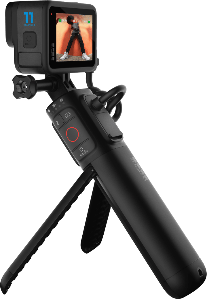 Black camera with a tripod. A screen shows a person. Has buttons.