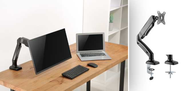 A desk with monitor arms and a laptop. A monitor is in portrait mode, and a laptop sits to its right.