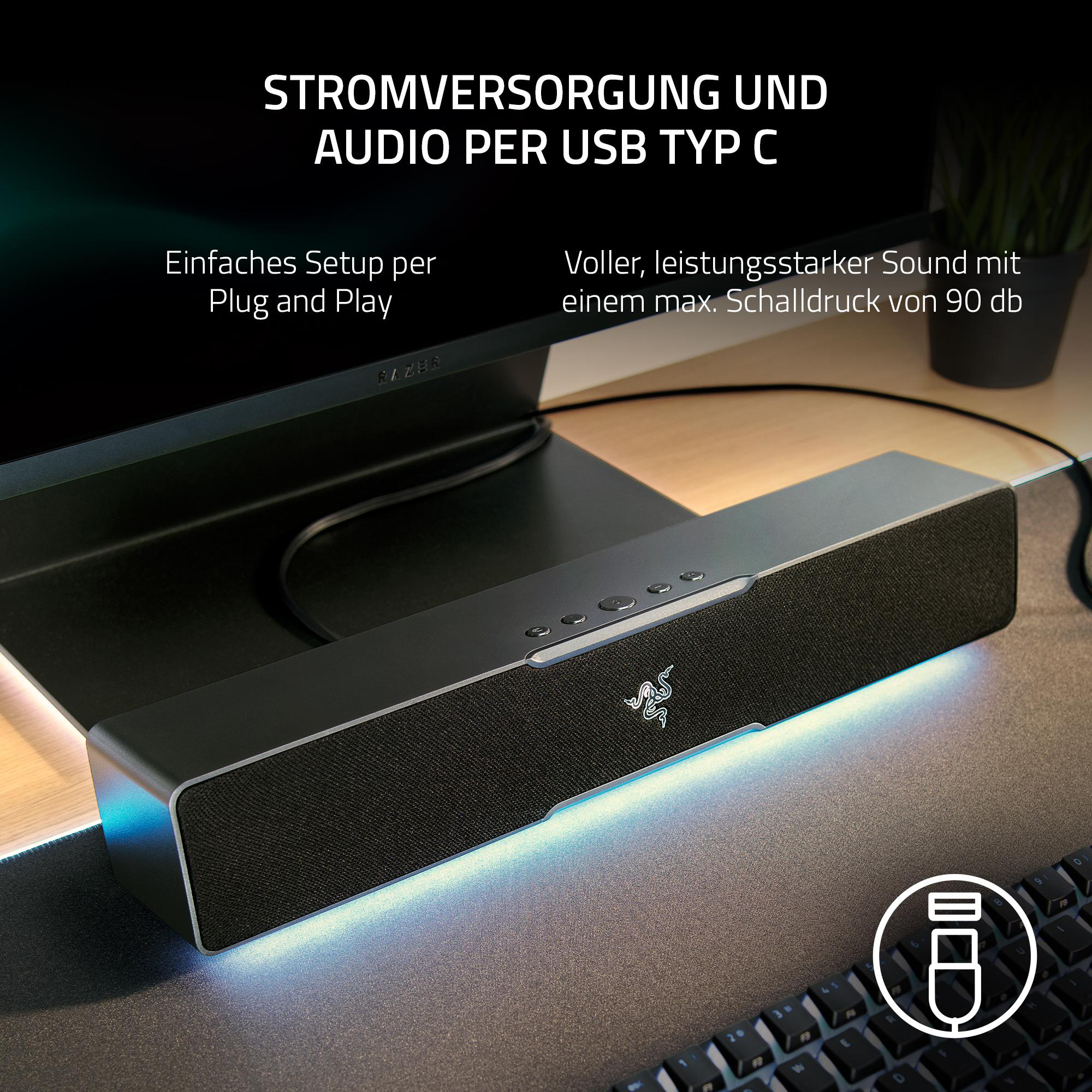 Schwarze Soundbar mit Razer-Logo. Text: Stromversorgung und Audio per USB Typ C.