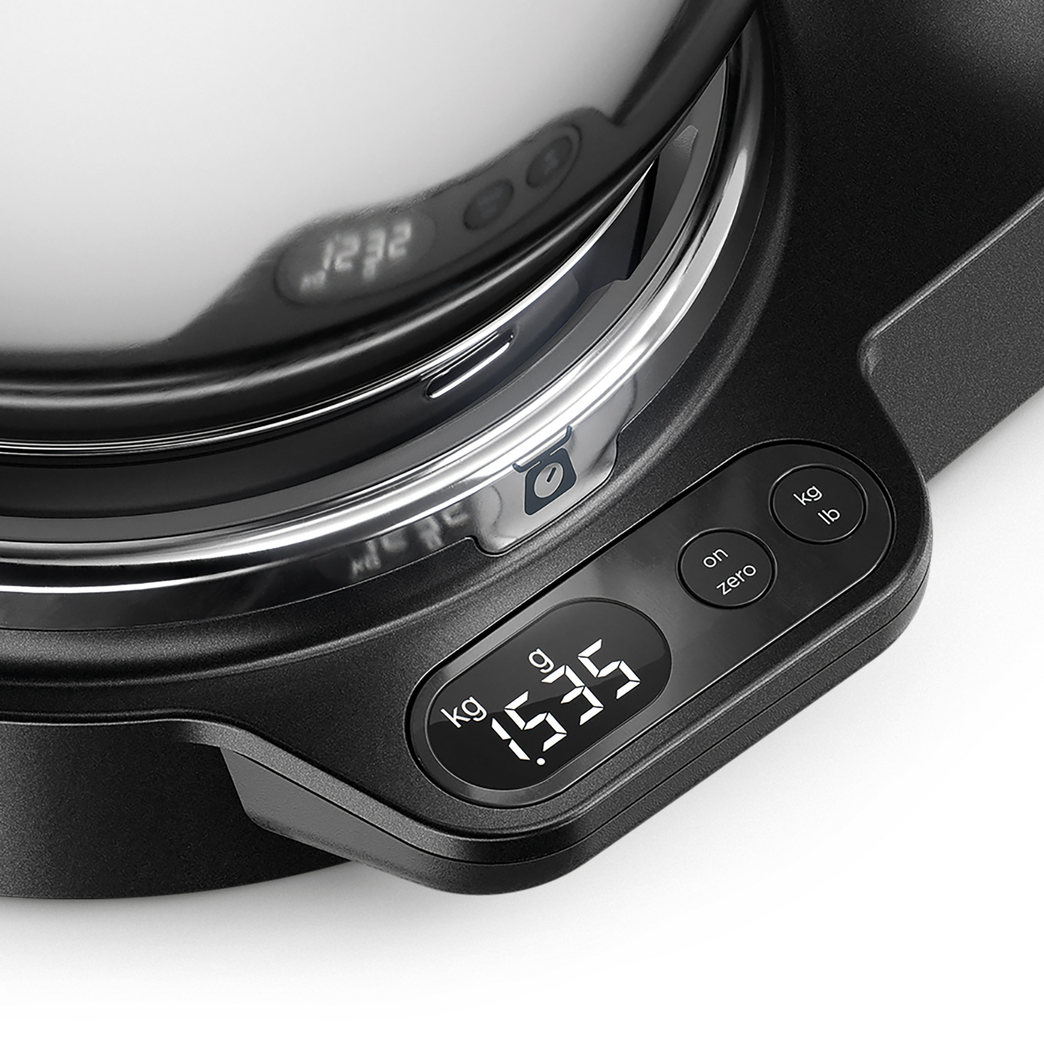 A black digital scale with a display showing 1535g. Buttons for kg, g, and lb are visible.