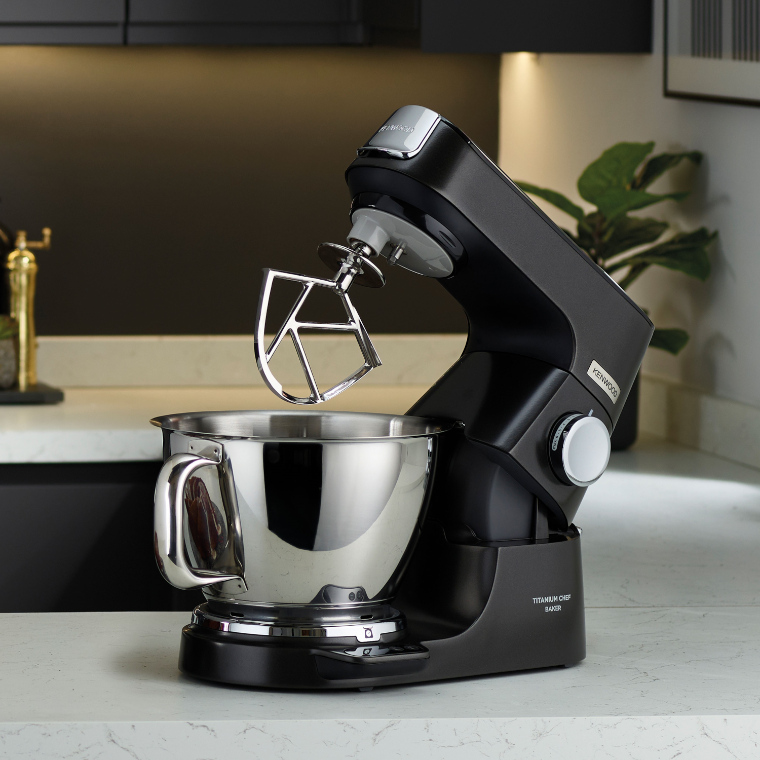 Black Kenwood Titanium Chef Baker kitchen appliance with a stainless steel bowl on a counter.