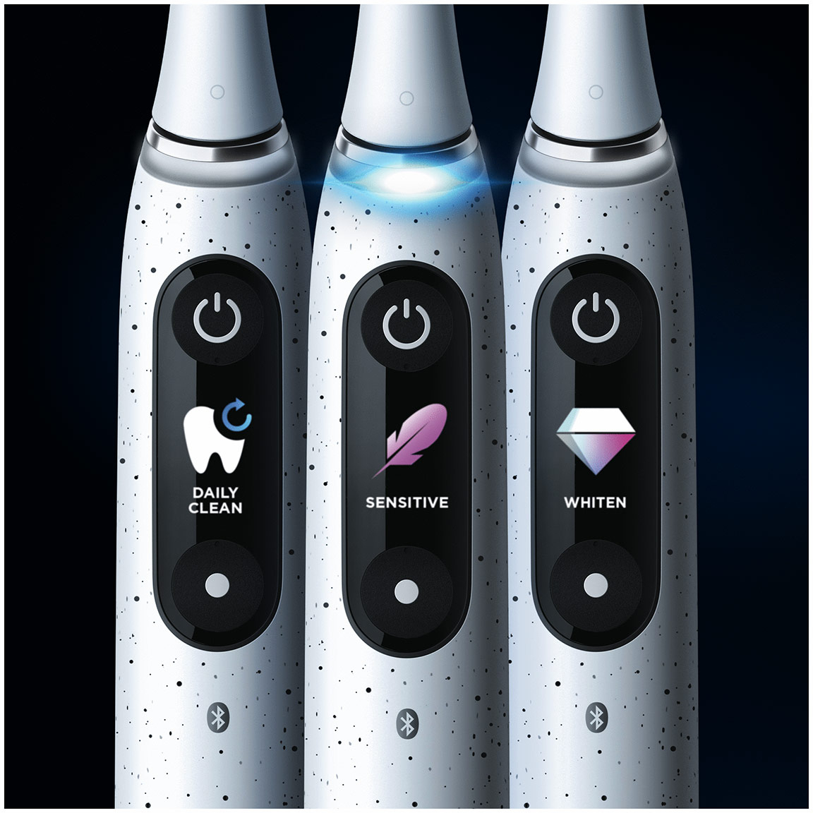 Trois brosses à dents électriques blanches avec différents modes de nettoyage allumés.