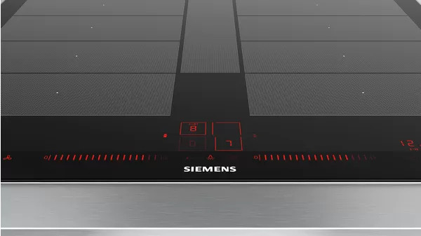 Close-up of a black Siemens induction cooktop with red illuminated controls.