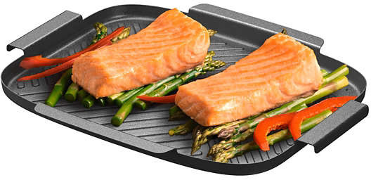 Two salmon fillets on a grill pan with asparagus and red pepper slices.