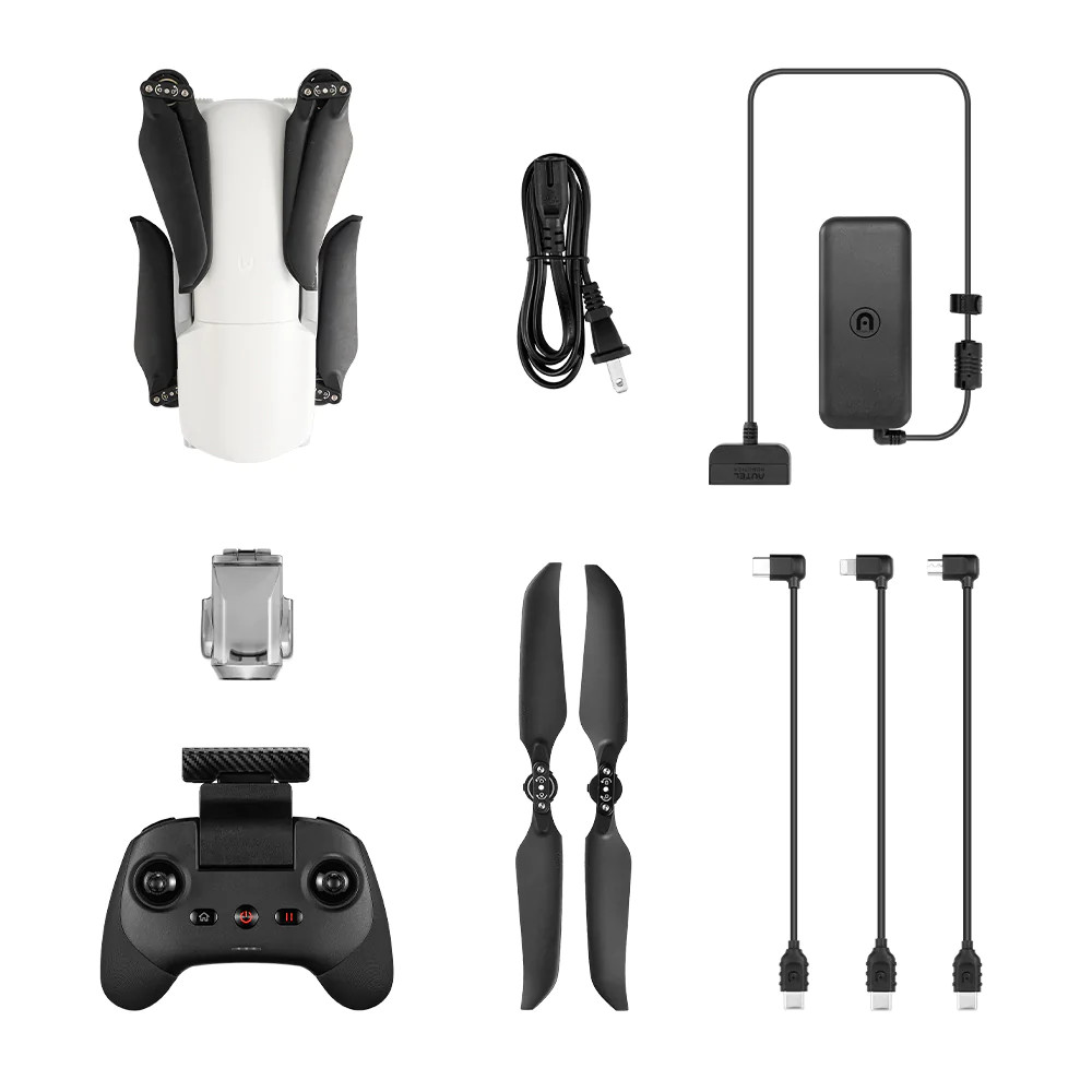 Drone et accessoires sur fond blanc. Comprend drone, télécommande, chargeur et câbles.
