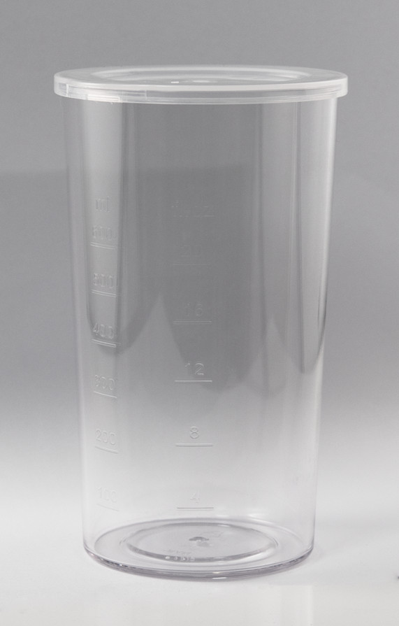 Clear plastic measuring cup with markings in ml and cups. The background is white.