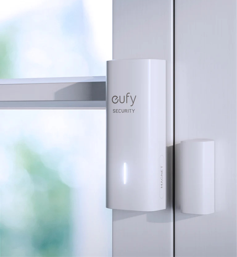 Witte Eufy beveiligingsdeursensor op een wit deurkozijn.