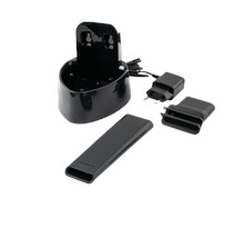 Black charging base with charger and two additional charging parts on a white surface.