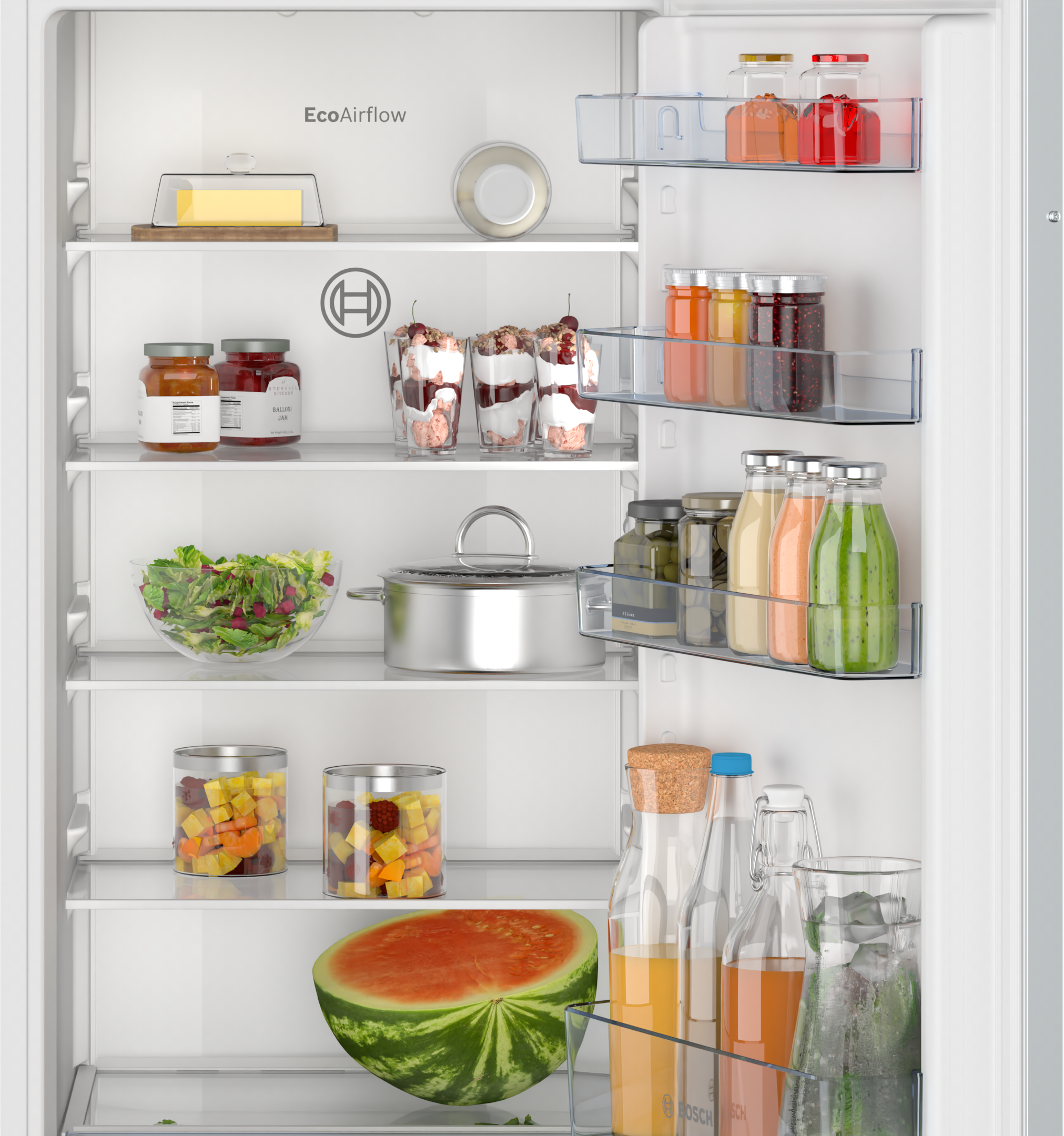 Refrigerator interior filled with food items like jars, salad, and drinks.