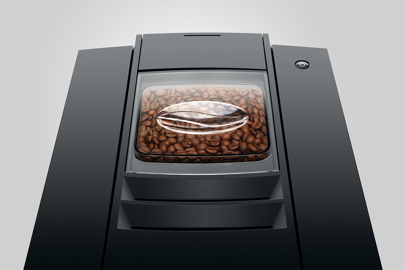 Kaffeemaschine mit Kaffeebohnen in einem transparenten Behälter.