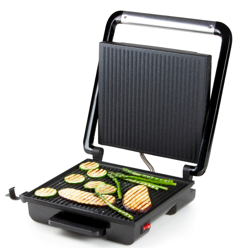 Open black grill with grilled vegetables. The grill is on a white background with an open lid.