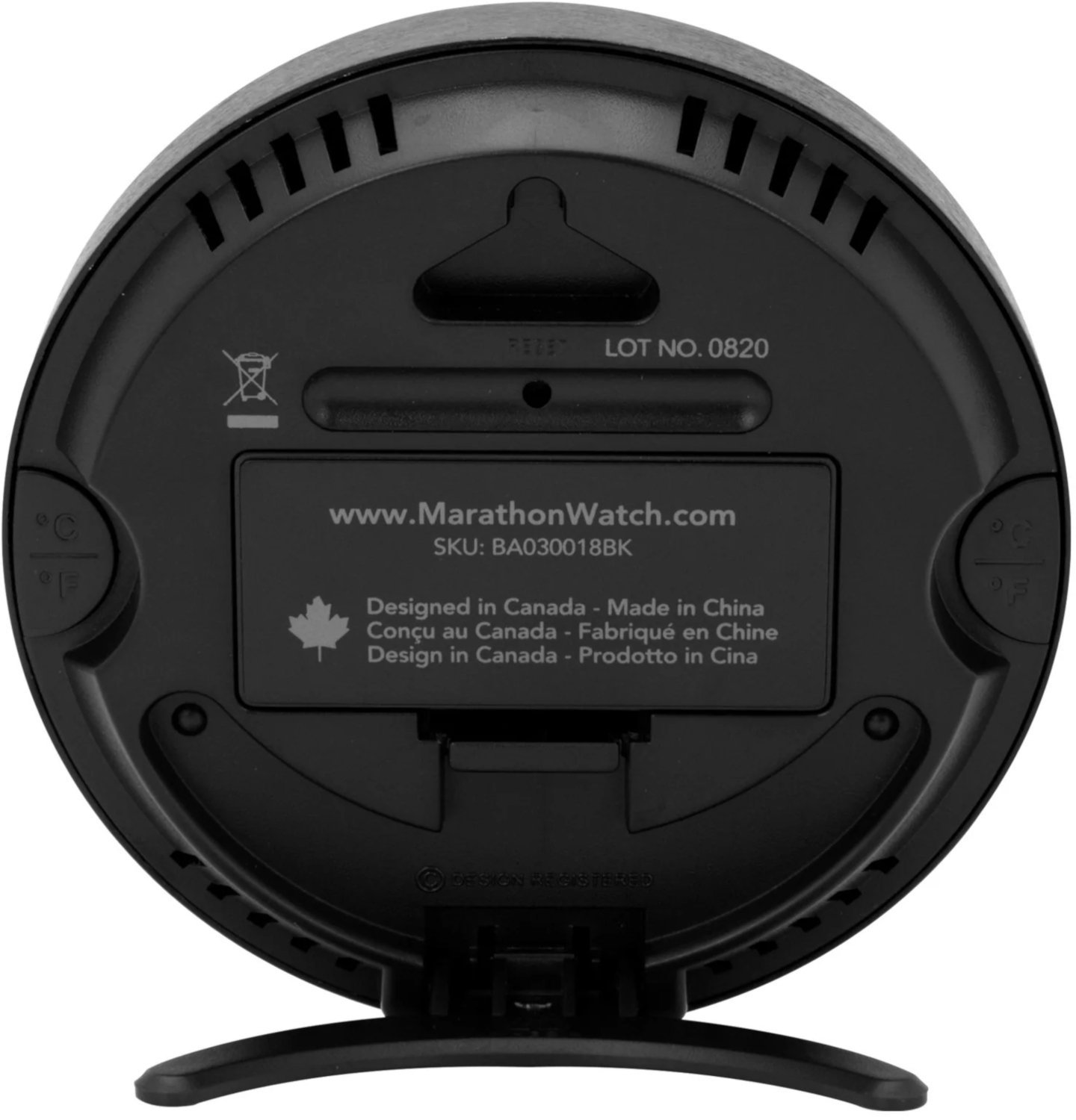 The back of a black round MarathonWatch clock with text and a stand.