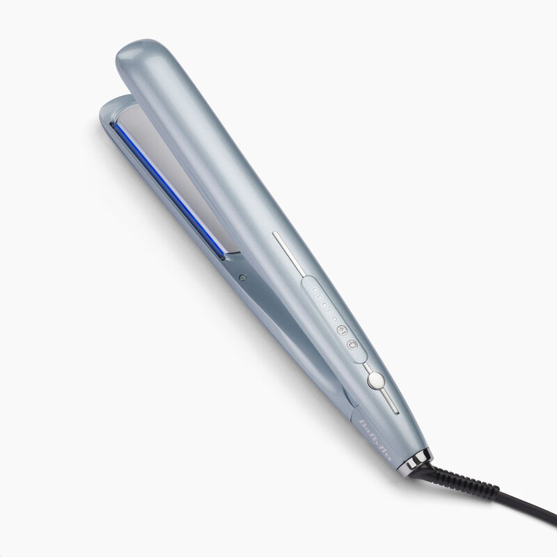 A light blue hair straightener on a white surface. It has a black cord attached.