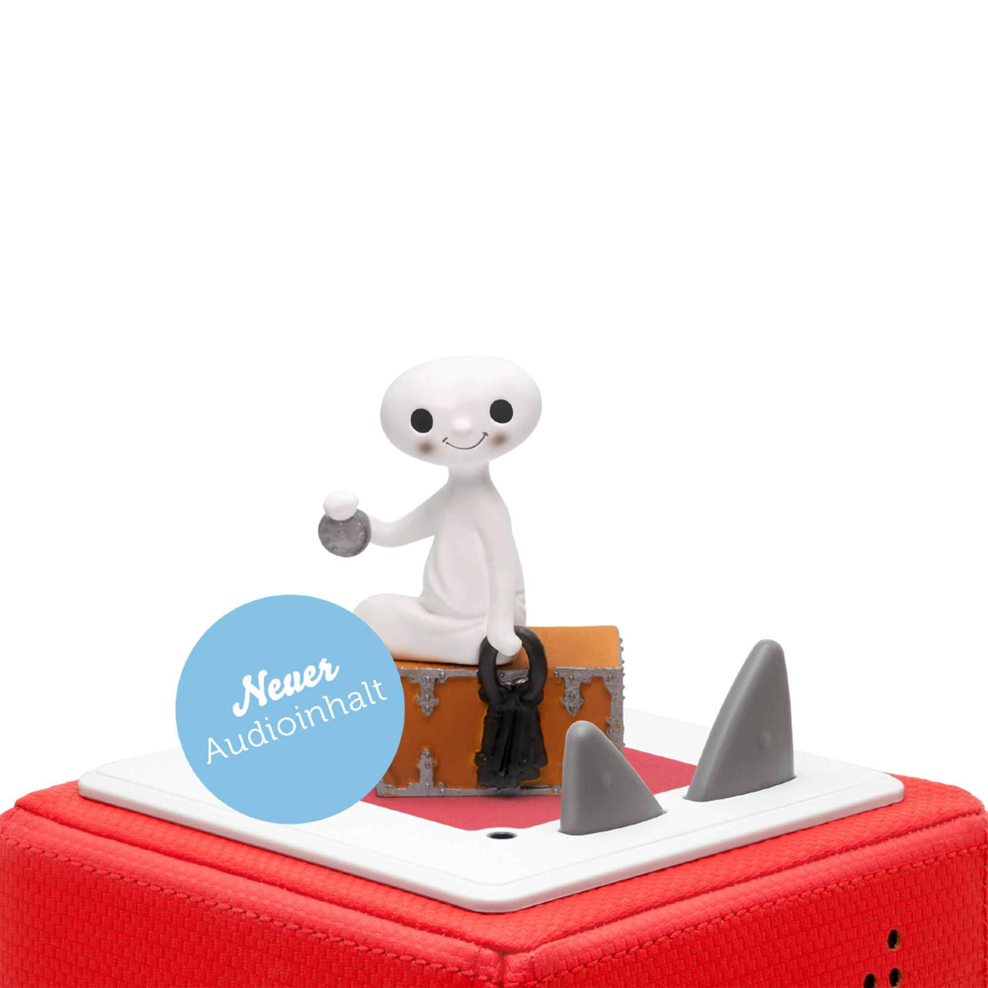 Eine weiße Figur sitzt auf einer Truhe mit Haifischflossen und einer Sprechblase.