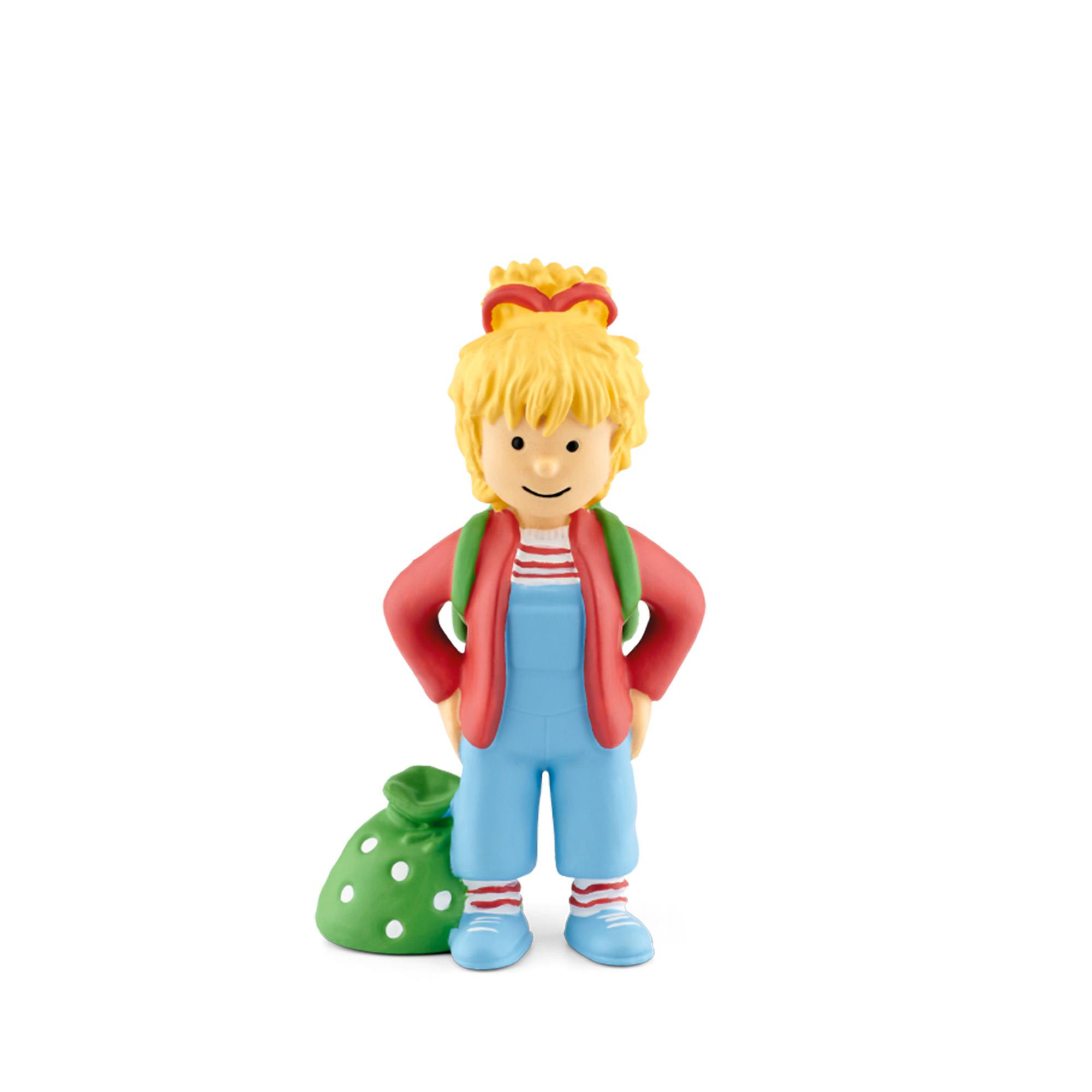 Eine Spielzeugfigur eines Kindes. Es ist ein Mädchen in Latzhosen, roter Jacke und grüner Tasche.