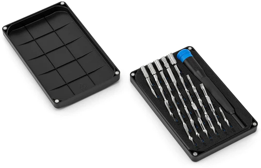 A set of precision screwdrivers in a black case. The case has an open lid on the left.