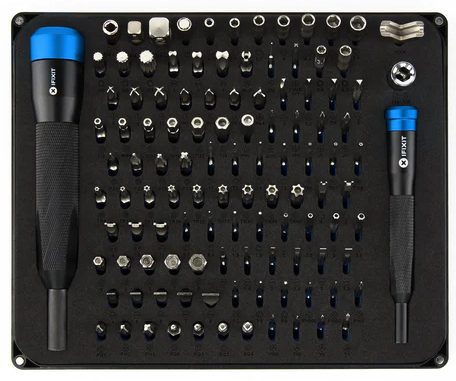 Tool set arranged neatly. Two screwdrivers on sides. Many different screwdriver bits in the middle.