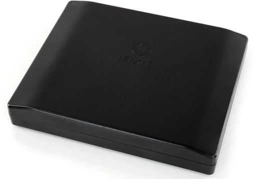 Black iFixit case, closed and rectangular, with the iFixit logo embossed on the top.