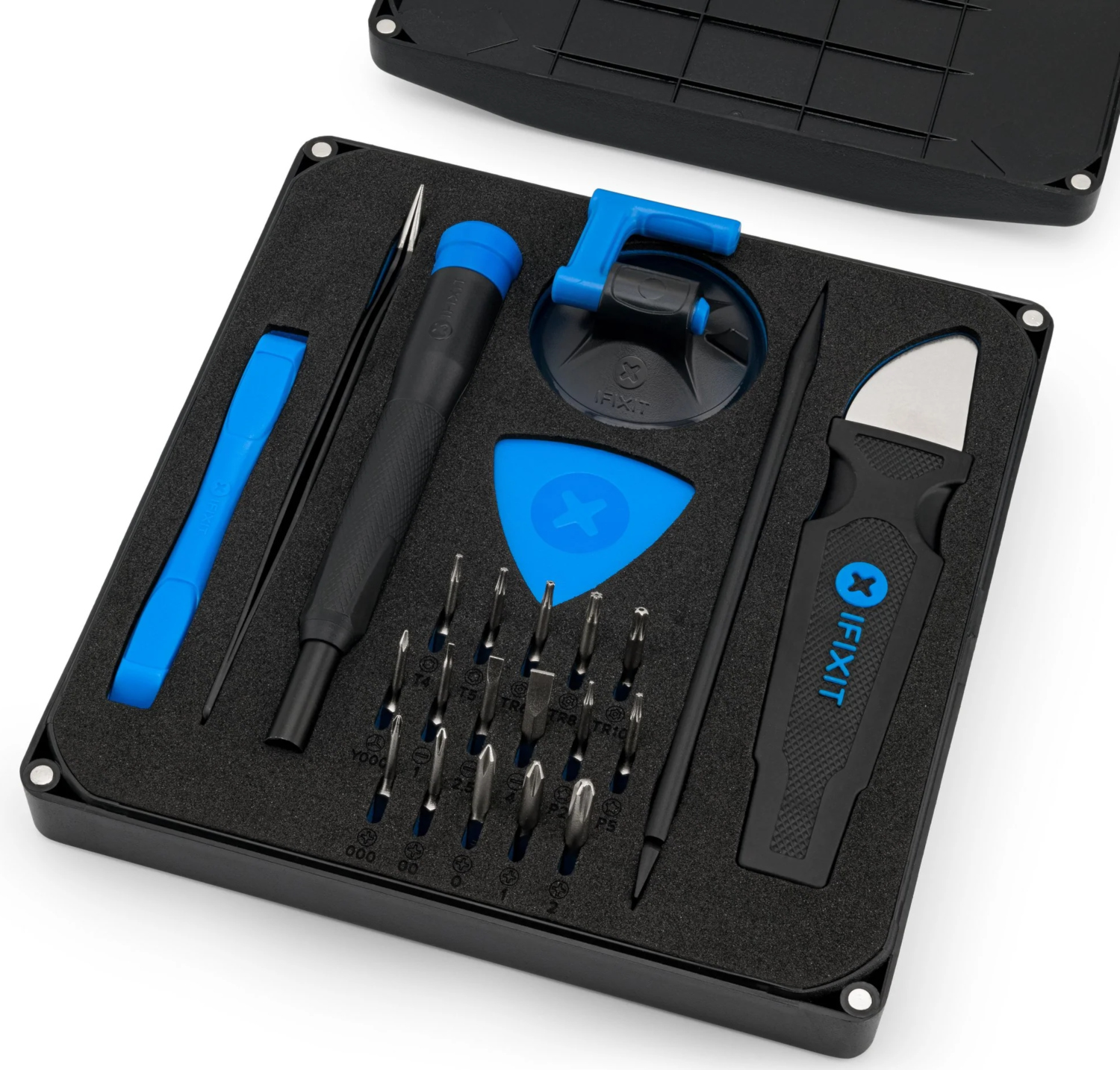 An open iFixit toolkit, tools organized in black foam. Screwdrivers, tweezers, and suction cup are visible.