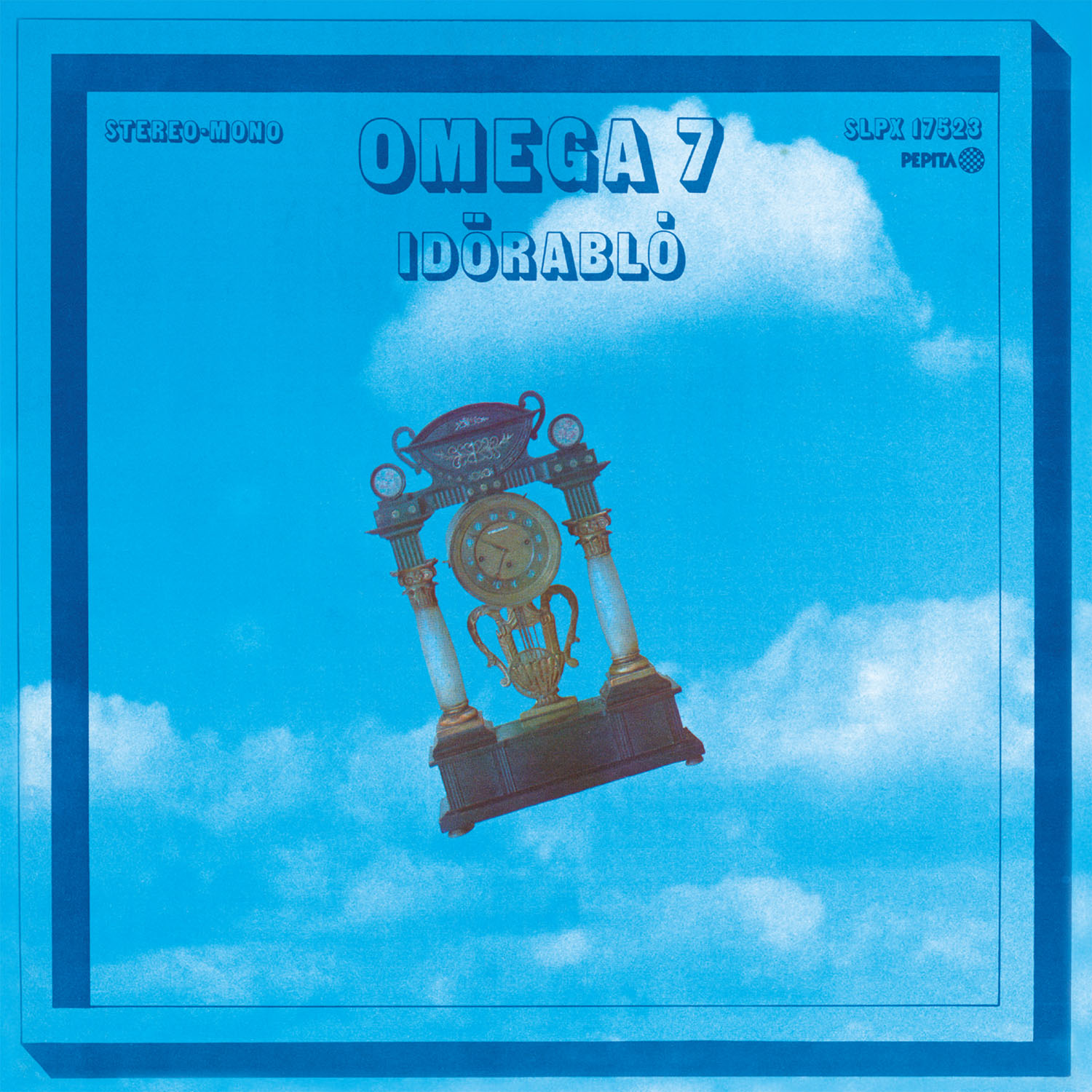 Omega 7 album borító, egy óra díszes dizájnnal, kék ég háttér előtt.