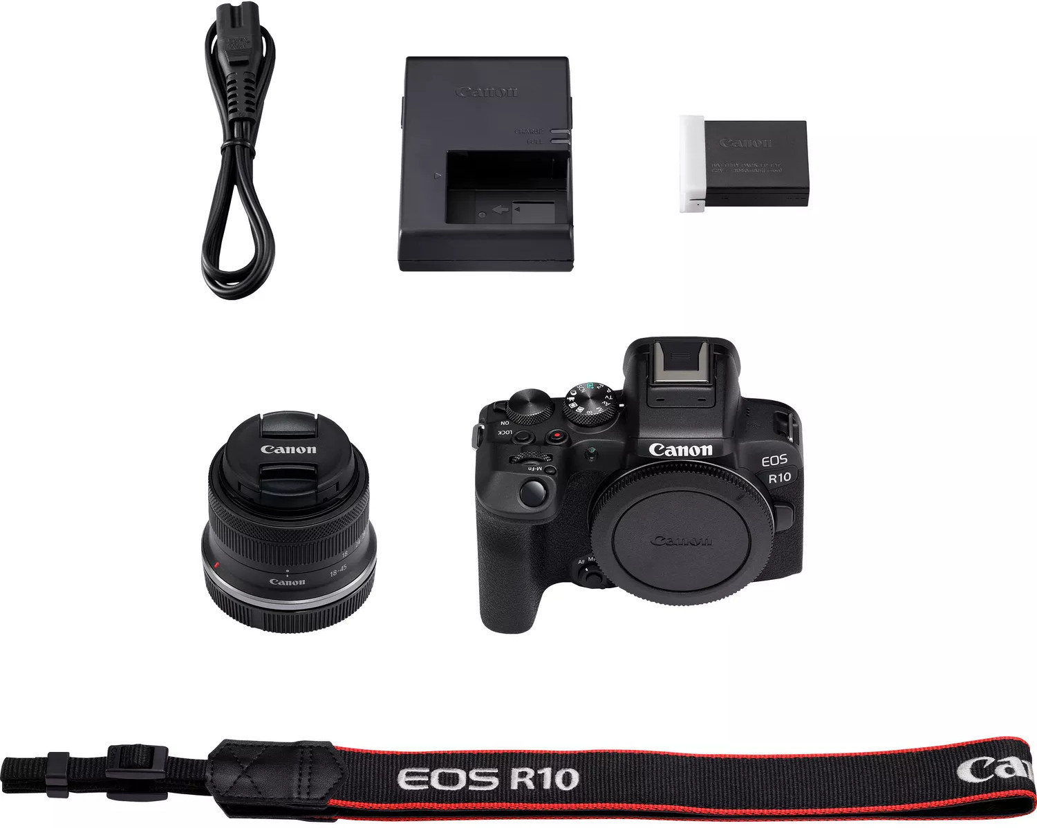 A Canon EOS R10 camera and accessories: charger, lens, strap, and cable, all arranged.