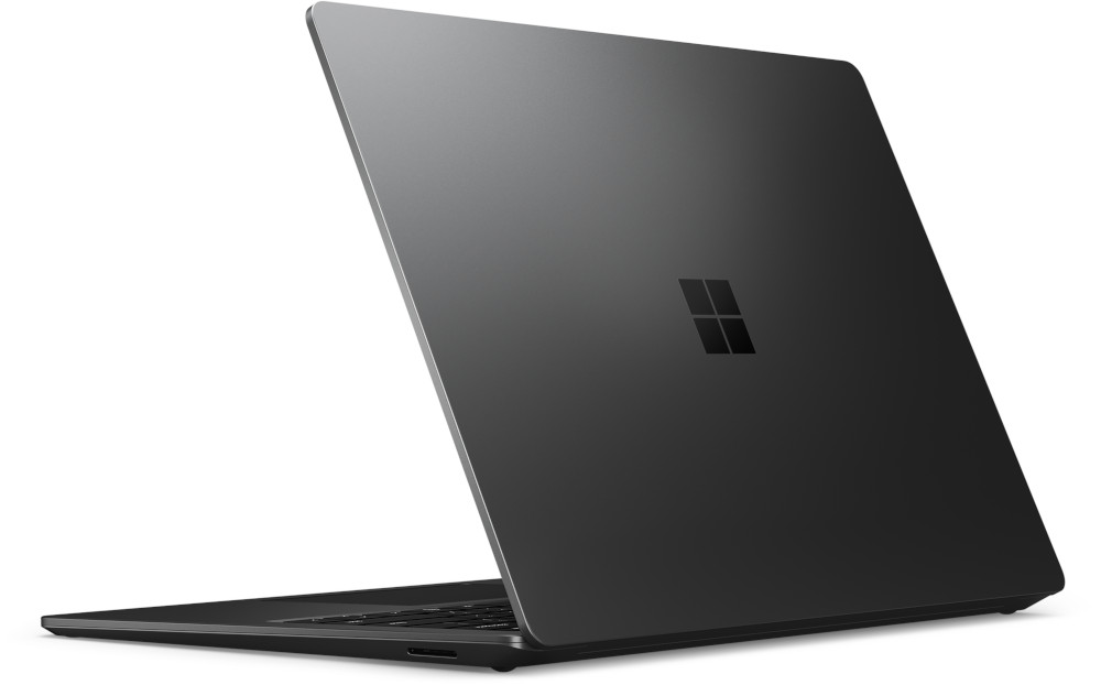 Un ordinateur portable noir montre son dos, avec le logo Microsoft dessus.