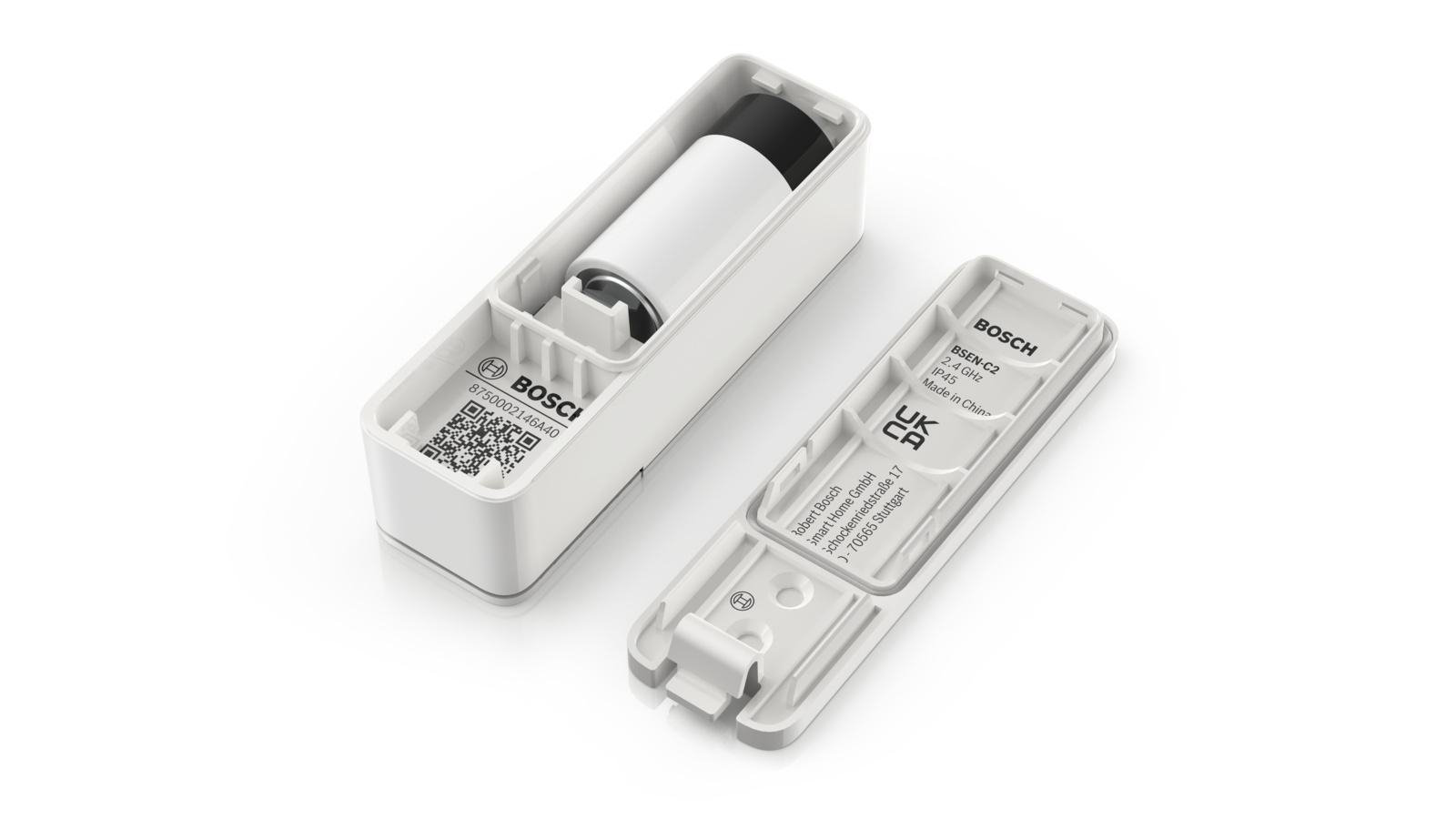 Weißes elektronisches Gerät mit abnehmbarer Oberseite, das eine Batterie freilegt. Weißer Hintergrund.