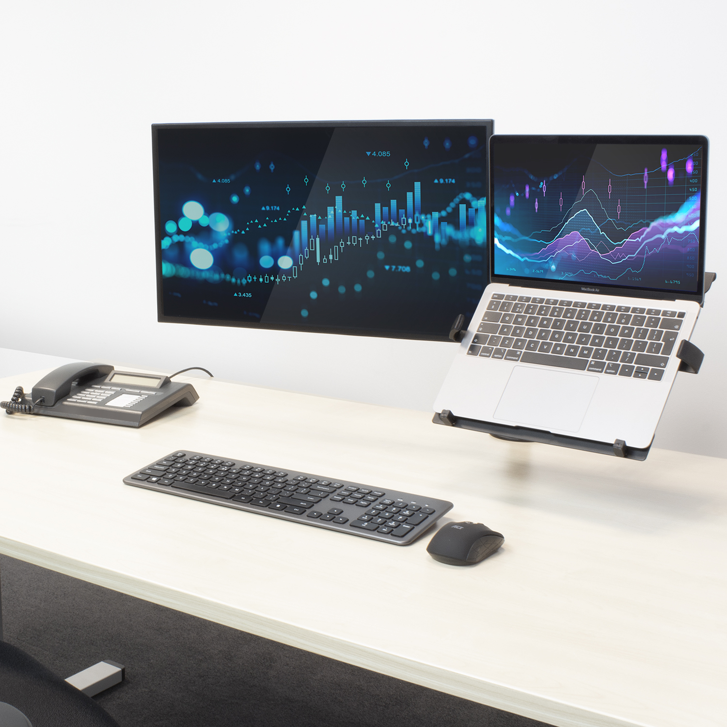 A desk setup with a monitor and laptop mounted. White desk.