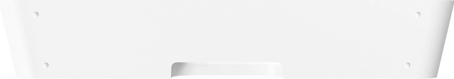 Fehér billentyűzet. Minimalista design, kis fogantyú-szerű bemélyedéssel elöl.