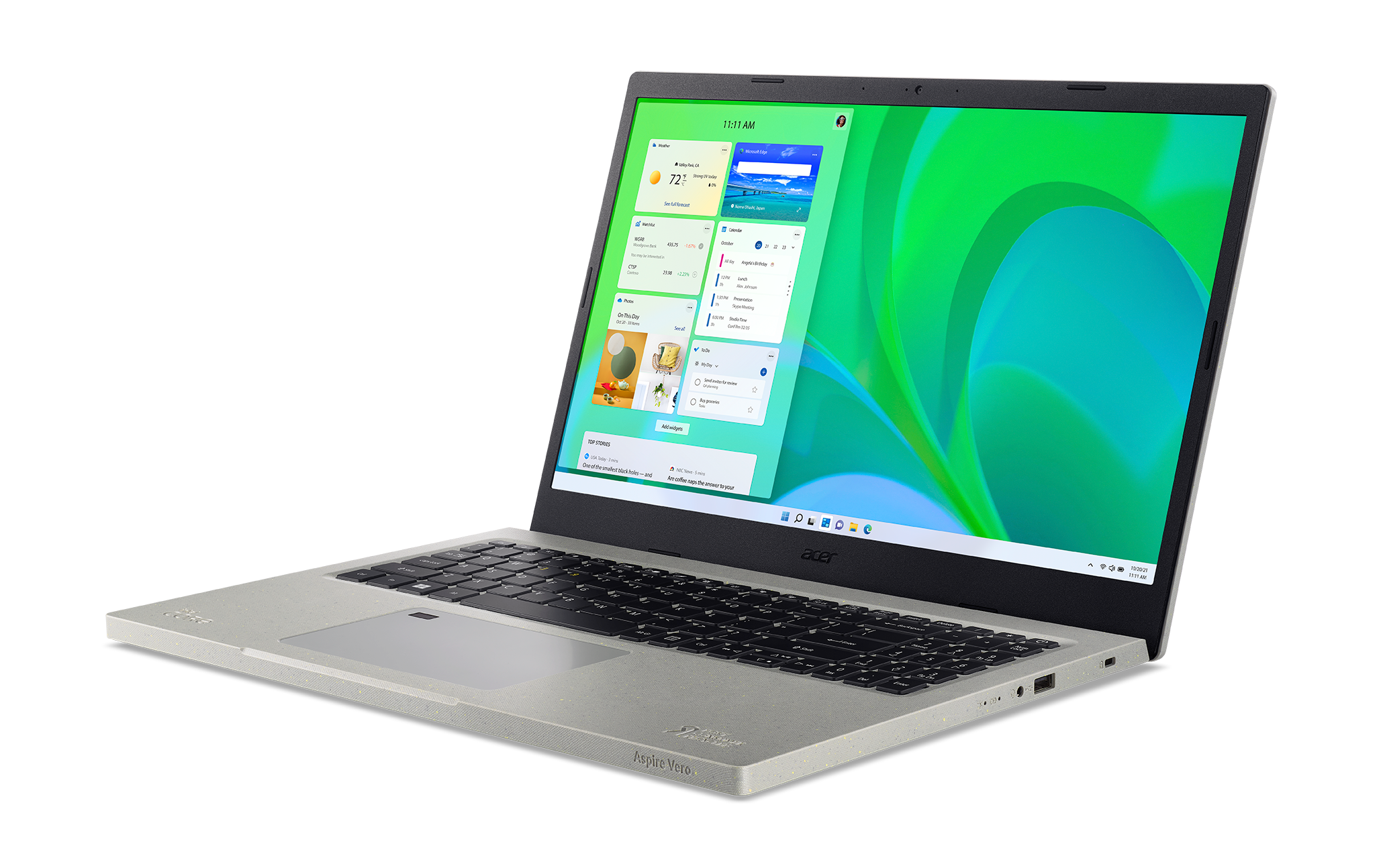 Una laptop con carcasa gris claro que muestra widgets en la pantalla, contra un fondo negro.